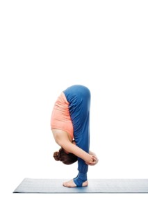 Woman doing Ashtanga Vinyasa Yoga Surya Namaskar Sun Salutation asana uttanasana, standing forward