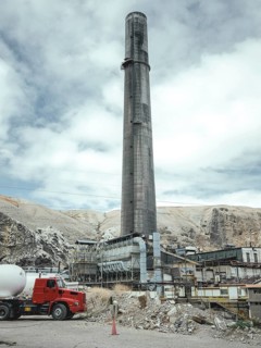Chimney of the smelter, in the foreground a spoil heap contaminated with heavy metal residues, La