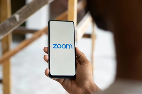Zoom Workplace logo is displayed on smartphone