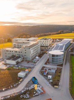 Sunset over an extensive industrial construction area in a rural landscape, new construction of the