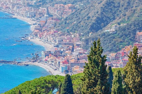 View of the Ionian coast and Giardini di Naxos in the distance, Taormina, Sicily, Italy