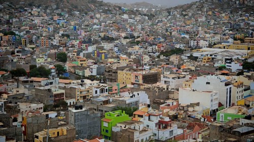 Mindelo from above, panoramic view of densely built, colorful buildings on a hill in gloomy