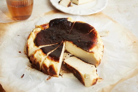 High quality image captures a freshly baked San Sebastian cheesecake, featuring its characteristic