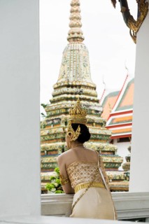 Thai traditionally and festively dressed young woman, Wat Pho, Bangkok, Thailand