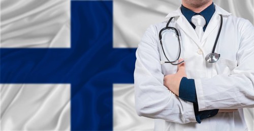 Male doctor with stethoscope on Finland flag. Doctor holding stethoscope on Finland flag