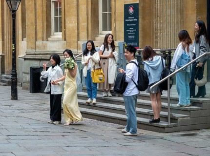 Asian couple women outside Register Office, Bristol, England, UK presumably after marriage or civil