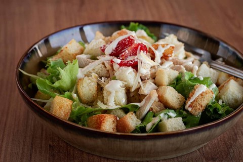 Classic Caesar salad, close-up, natural light, selective focus, horizontal