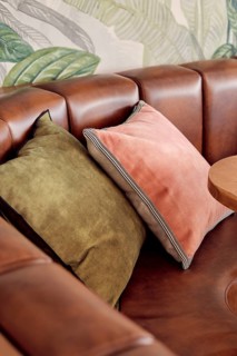 This image showcases a detailed view of a stylish restaurant seating area, featuring a richly