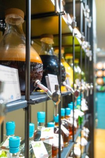 Close-up of glass bottles with different liquids and screw caps on shelves, Sindelfingen, Germany