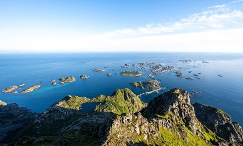 View of numerous small rocky islands with houses, at the summit of Festvågtind, view of