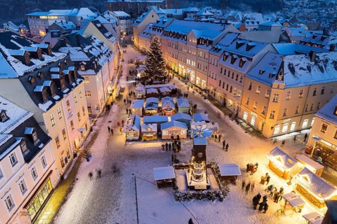 The snow-covered Christmas market seen from the town hall tower, Schneeberg in the Ore Mountains,