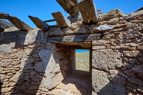 View from the window of an old mill ruin with a view of the surrounding landscape and the sky,