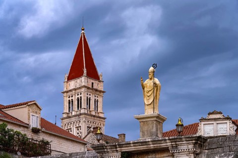 Statue of the patron saint Ivan Ursini on the city gate and the tower of the Cathedral of St