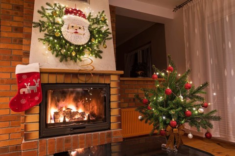 Christmas floral decoration in front of firepace.