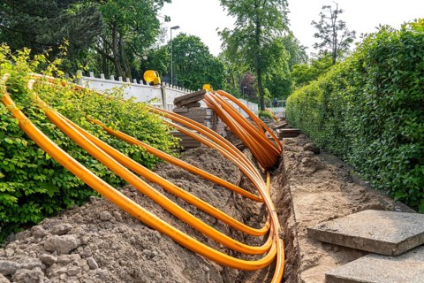 Laying of fibre optic cables, empty conduits are laid under a pavement, in which the actual fibre