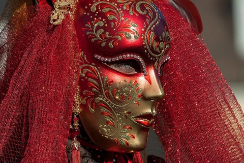 Venetian carnival mask and costumes at the Venetian fair on the historic market square,