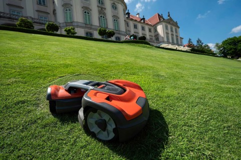 A robot mower mows the grass on a slope, Warsaw, Poland