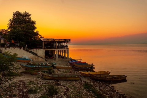 Beautiful orange summer sunset at Shkoder Lake in Shiroka Municipality. Albania