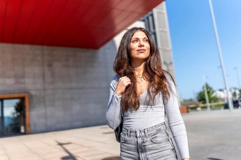 Beauty caucasian casual woman enjoying walking along the city under the sun