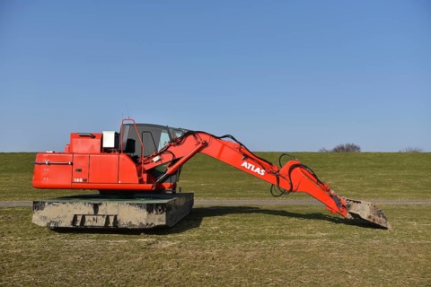 Excavator for dyke processing, coastal protection, Brunsbüttel, Schleswig-Holstein, Germany