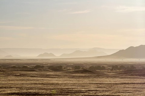 Rolling hills and mist under morning light in a vast desert landscape, Sossusvlei landscape,