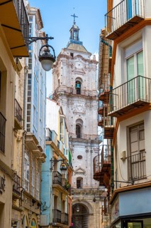 City view with an imposing church tower and neighbouring narrow streets, Malaga, Spain