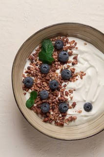 Yogurt with chocolate muesli, with berries, blueberries, breakfast, close-up, fork on top, no