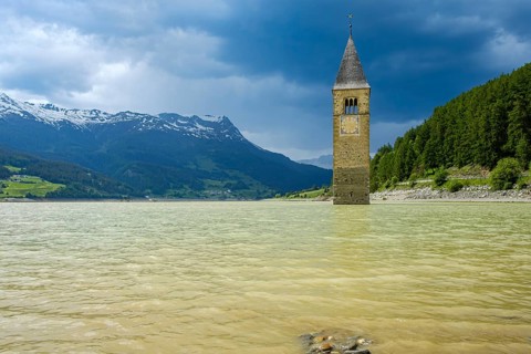 Bell tower of the former parish church of St Catherine in the sunken village of Alt-Graun in Lake