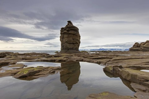Sandstone rock formation on beach along the coast of Boltodden, Kvalvagen, Svalbard, Spitsbergen,