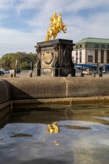 Equestrian statue of the Golden Horseman with reflection in the Nymphenbrunnen fountain, Neustädter
