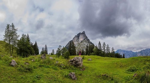 Hiker on the Schartenalm with a view of the Sparber, Osterhorn group, Salzkammergut, Salzburg
