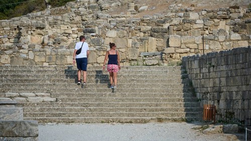 Couple walking up a stone staircase in an ancient ruins site, Kamiros, Archaeological site, Ancient