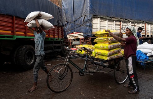GUWAHATI, INDIA - MAY 1: Labourers carries goods in a wholesale market, in Guwahati, India, on May