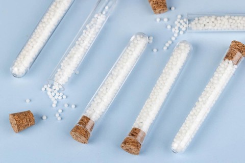 Corks and test tubes filled with white globules on a blue background