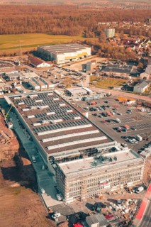 Industrial complex with solar systems and parking spaces in an urban autumn environment, PV