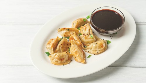 Japanese fried gyoza dumplings, with pork, sesame seeds, green onions