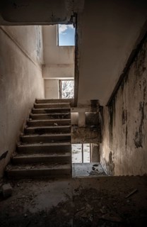 Abandoned destroyed staircase in a residential building, Soviet apartment blocks, ghost town,