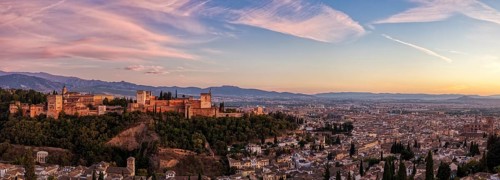 Panorama from a distance of the Alhambra and the city in the warm light of sunset, Granada