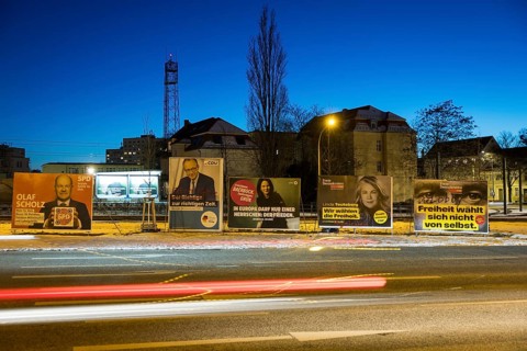 Election posters of the parties SPD, CDU, Bündnis 90/Die Grünen and FDP behind the lights of