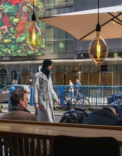 View through the window of a café of passers-by on Friedrichstraße in Mitte, Berlin, Germany