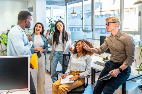 Multi ethnic business team collaborating and sharing ideas in a modern coworking office space,