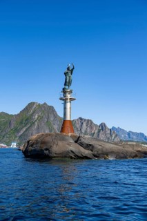 Figure Fiskerkona at the harbour of Svolvaer, mountains and sea, Lofoten, Nordland, Norway