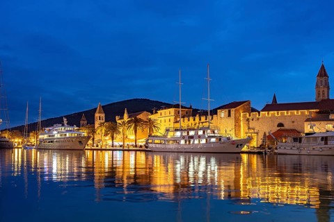 Cruise ships in front of the old town centre of Trogir at dusk, Croatia
