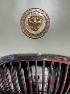 Historic old coat of arms logo with head of Jaguar and lettering Jaguar Cars Ltd Coventry on beige