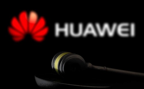 Court gavel in front of the Huawei logo.