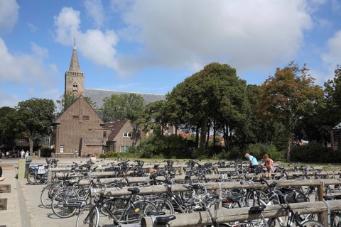 Church and bicycle parking, bicycles parked at the parking lot, cycling, parking lot, Den Burg,