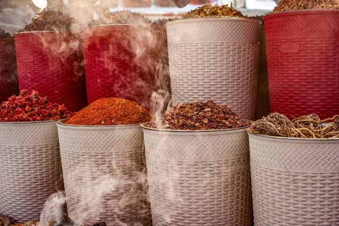 Dubai, United Arab Emirates. July 1st 2019 Incense burning alongside coloured spices for sale in