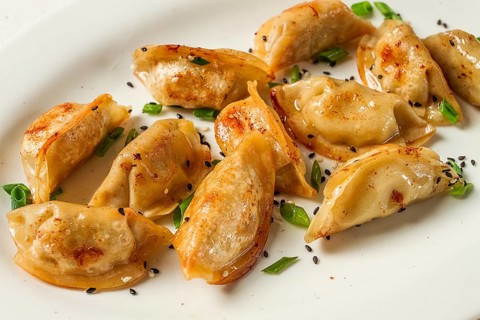 Japanese fried gyoza dumplings, with pork, sesame seeds, green onions