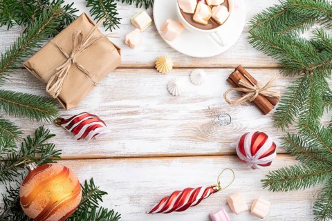 Christmas or New Year frame composition. Decorations, box, balls, cinnamon, ribbons, fir and spruce