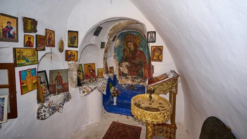 Small chapel full of religious icons and murals in an intimate atmosphere, Panagia Thermiani